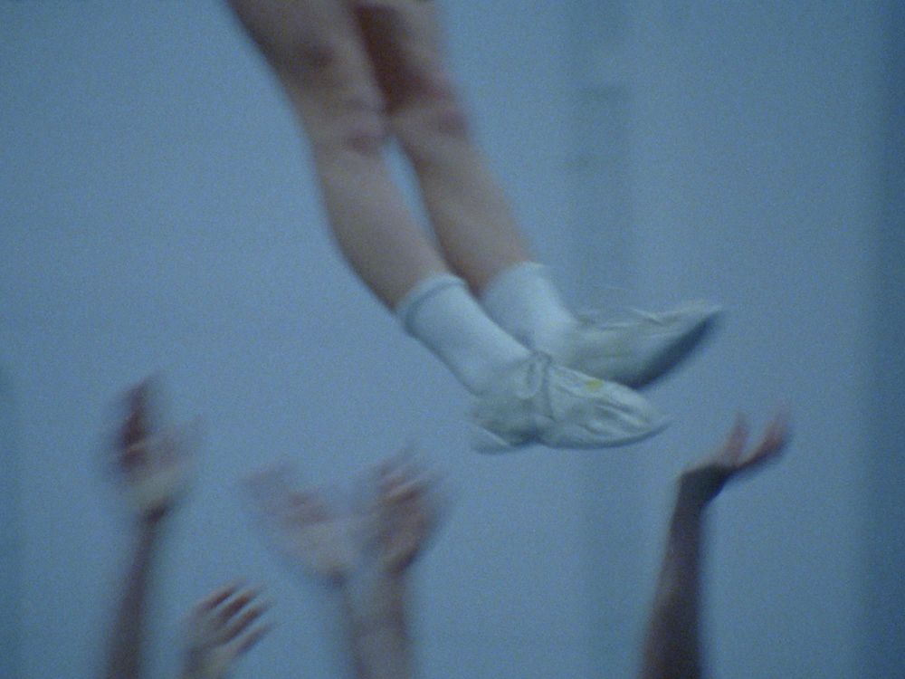 A slightly out-of-focus shot of a pair of legs mid-air.