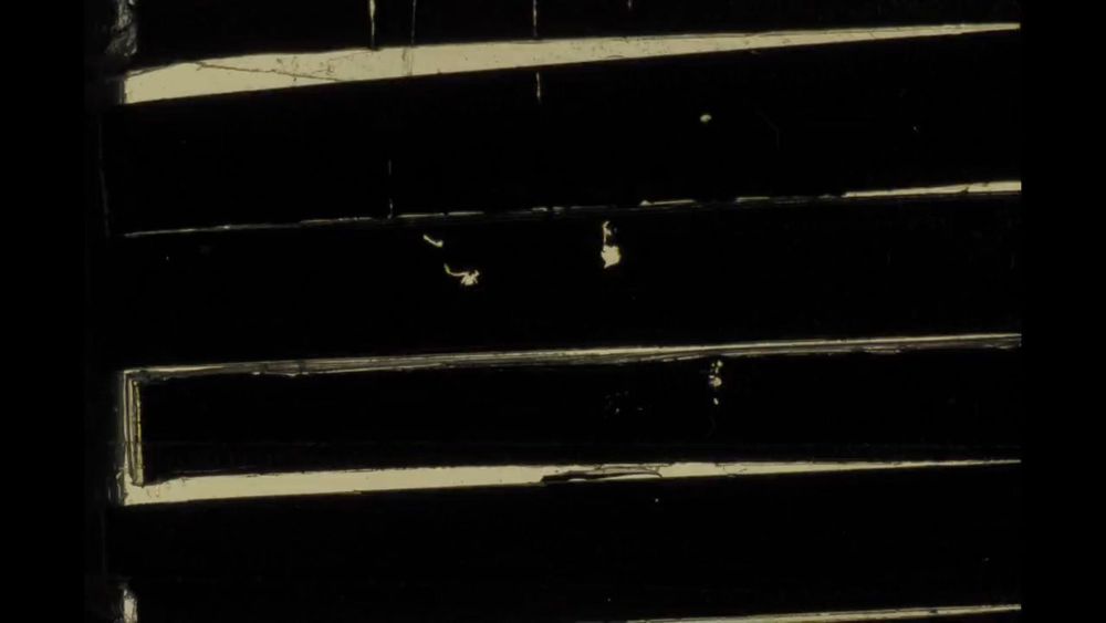 Predominantly black images with slivers of light peeking through, as if looking through blinds.